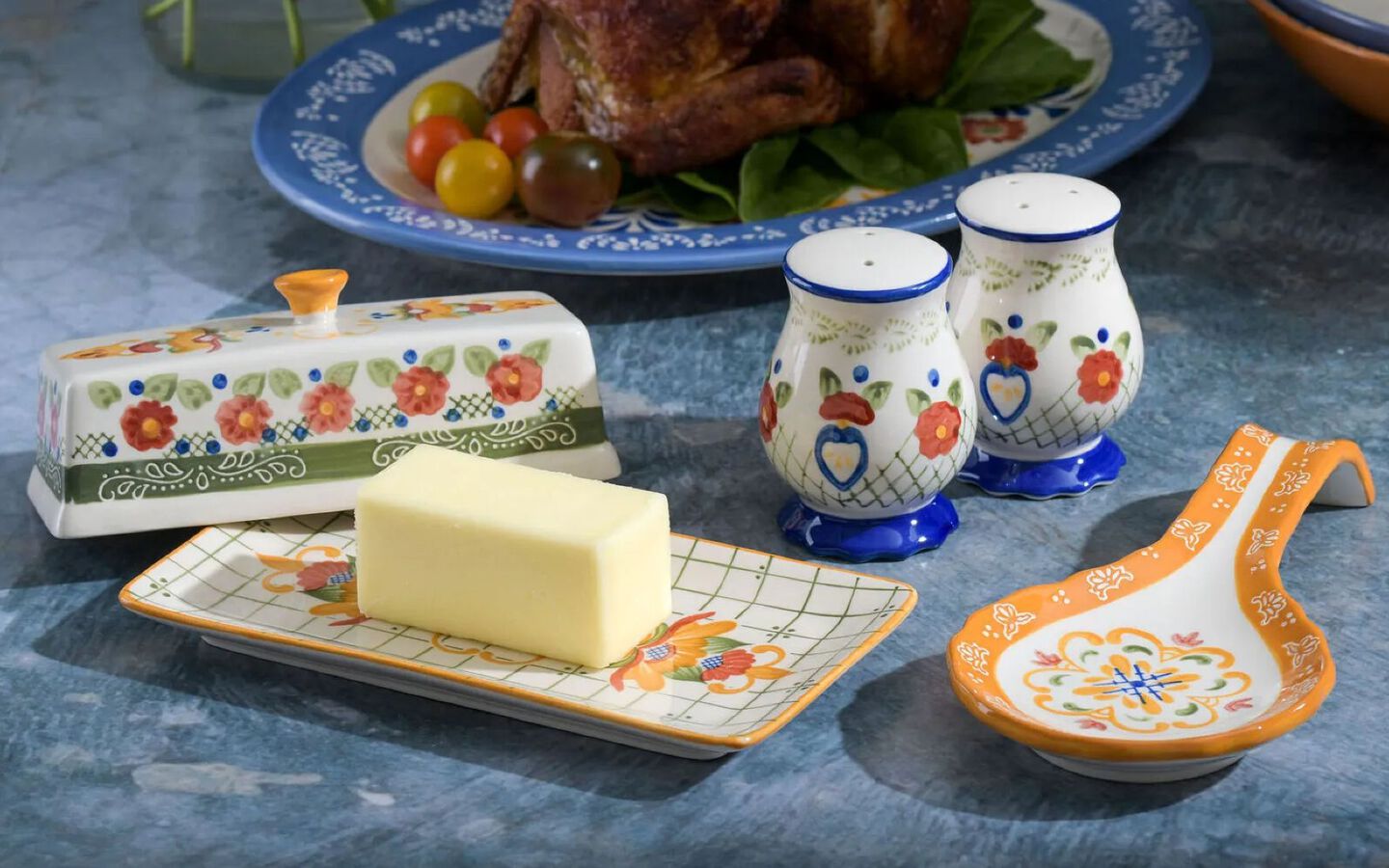 Blue, green, and yellow colorful spoon holder, butter dish, and salt and pepper shakers