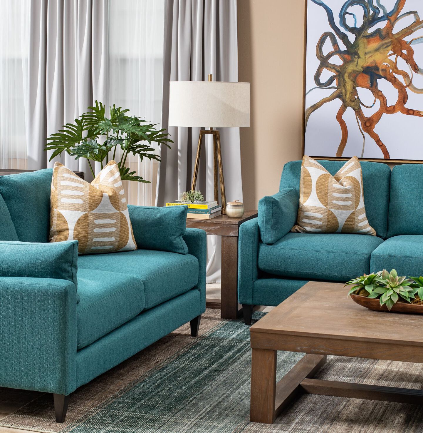 Living room with brown coffee table, a brown side table, and two teal sofas