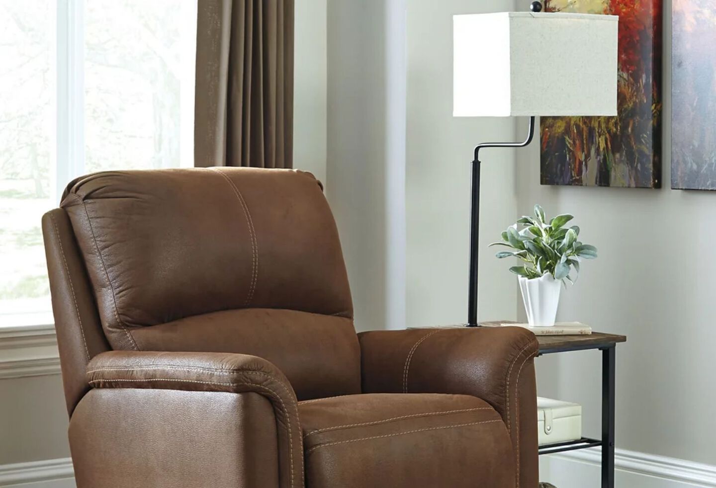 Living room with brown leather recliner, lamp, and side table