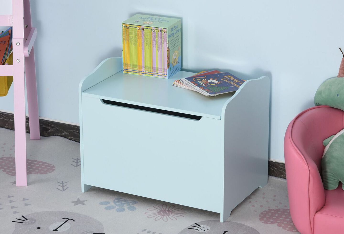 Kid's bedroom with a light blue storage cabinet with books on top