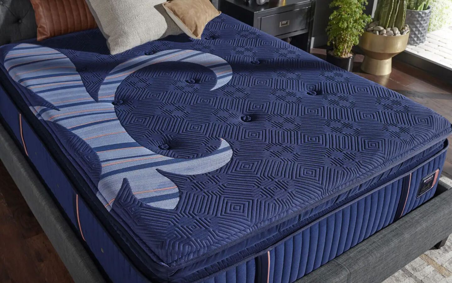 Aerial view of a Stearns & Foster navy blue mattress on a grey bedframe