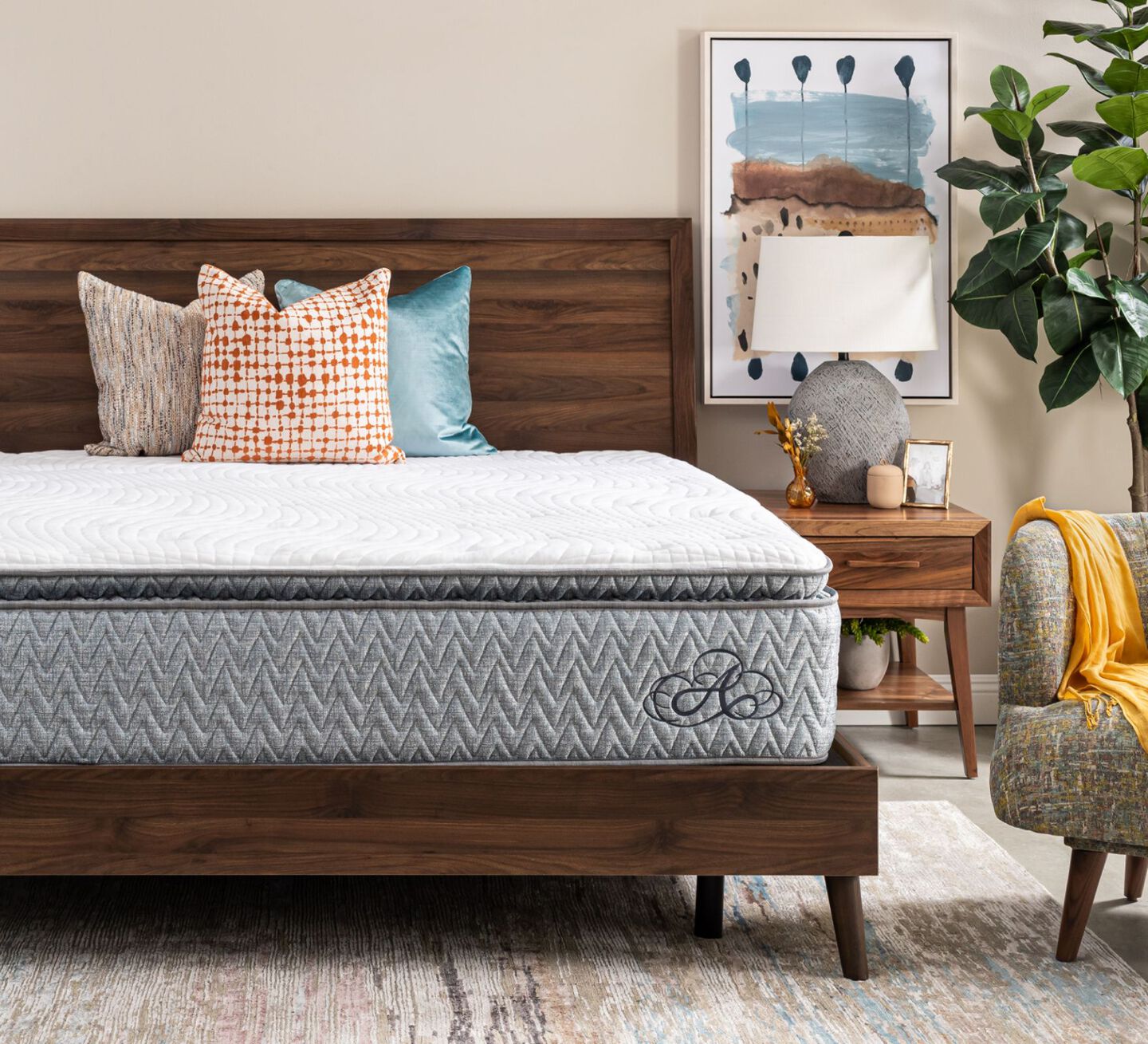 Americana mattress on a wooden bedframe with three pillows on top