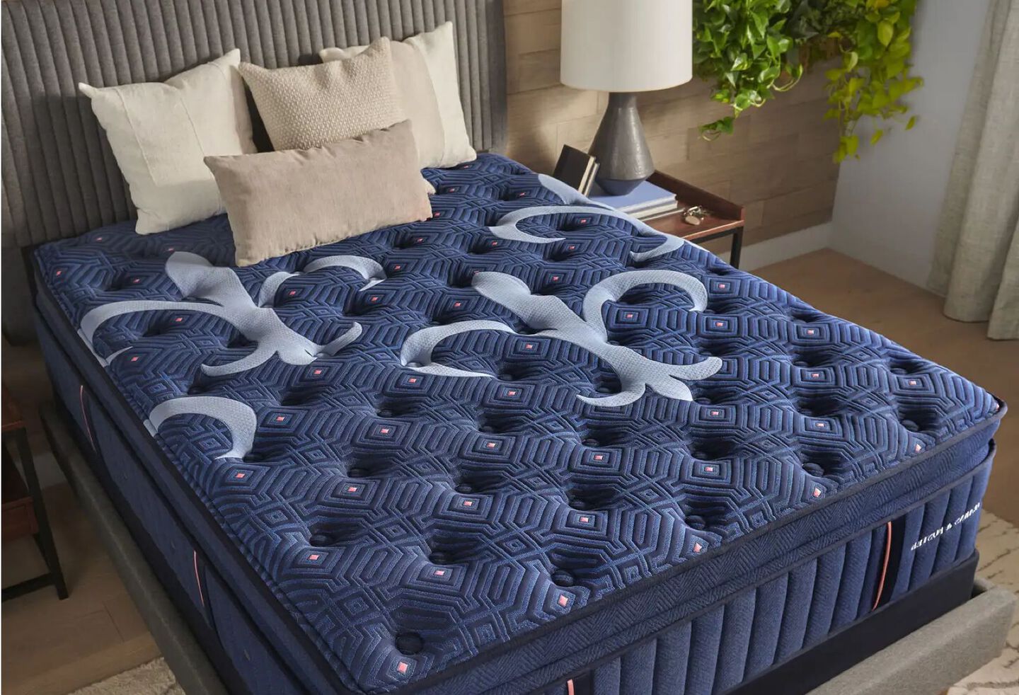 Navy blue Stearns & Foster mattress with three beige pillows on top