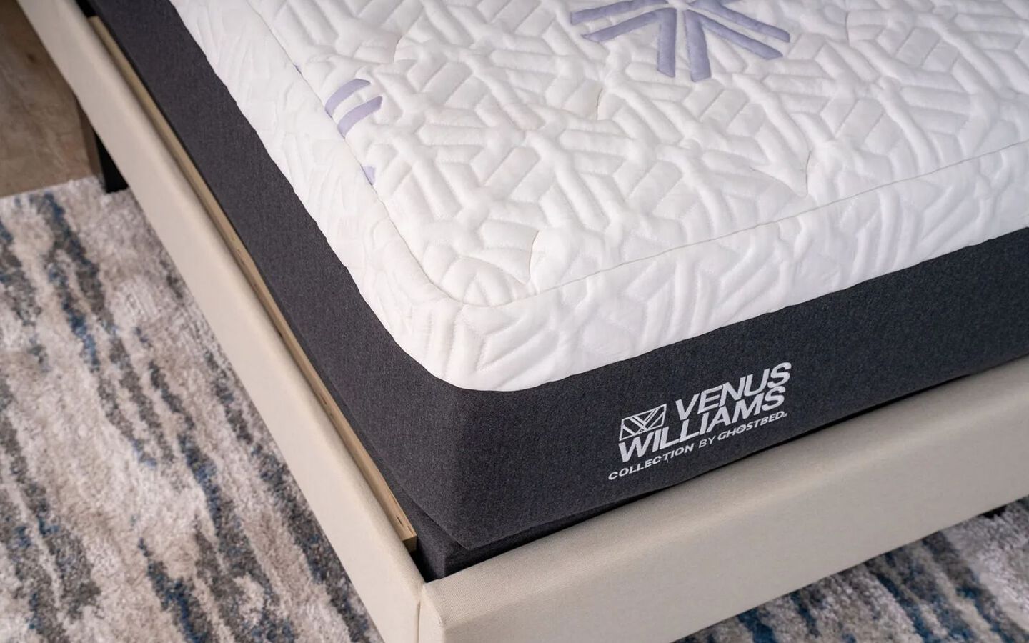 Close-up of a Venus Williams mattress on a beige bedframe