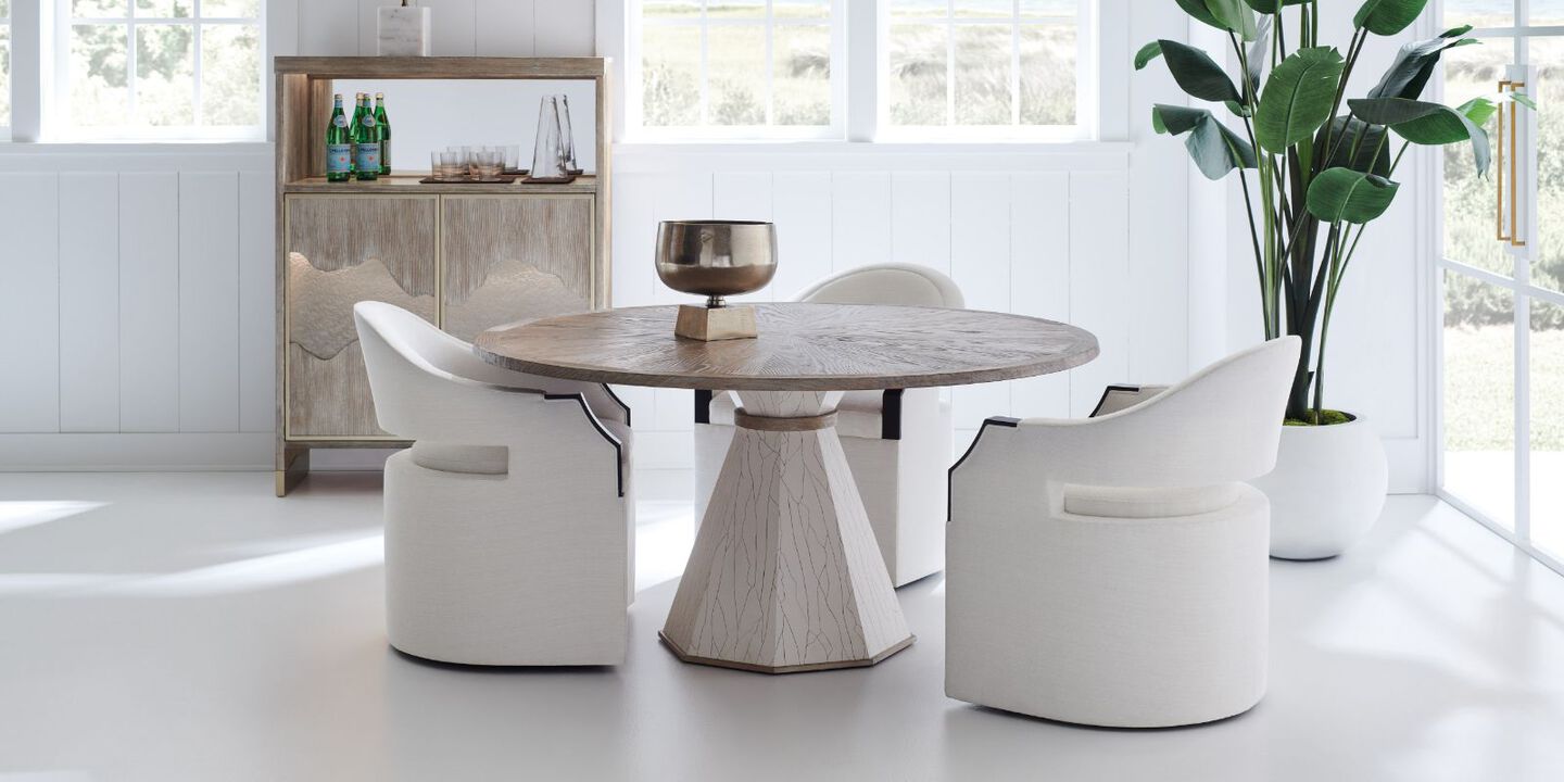 wooden angular table surrounded by white plush rounded chairs