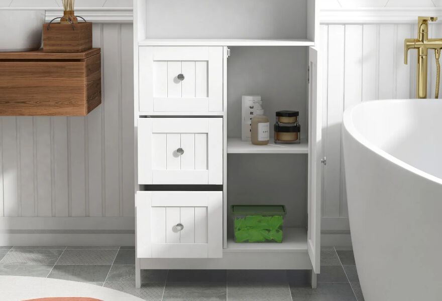 White bathroom storage cabinet with bathroom supplies inside