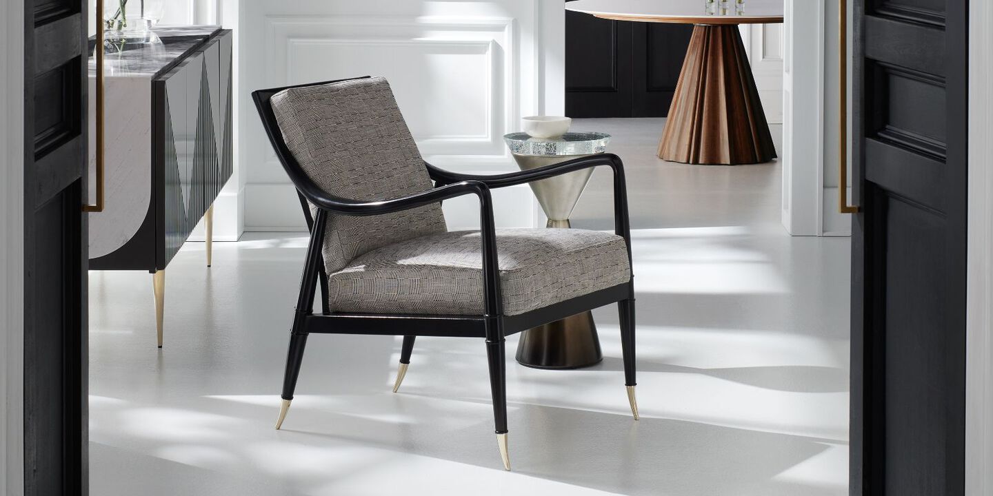 light grey and black chair with gold feet
