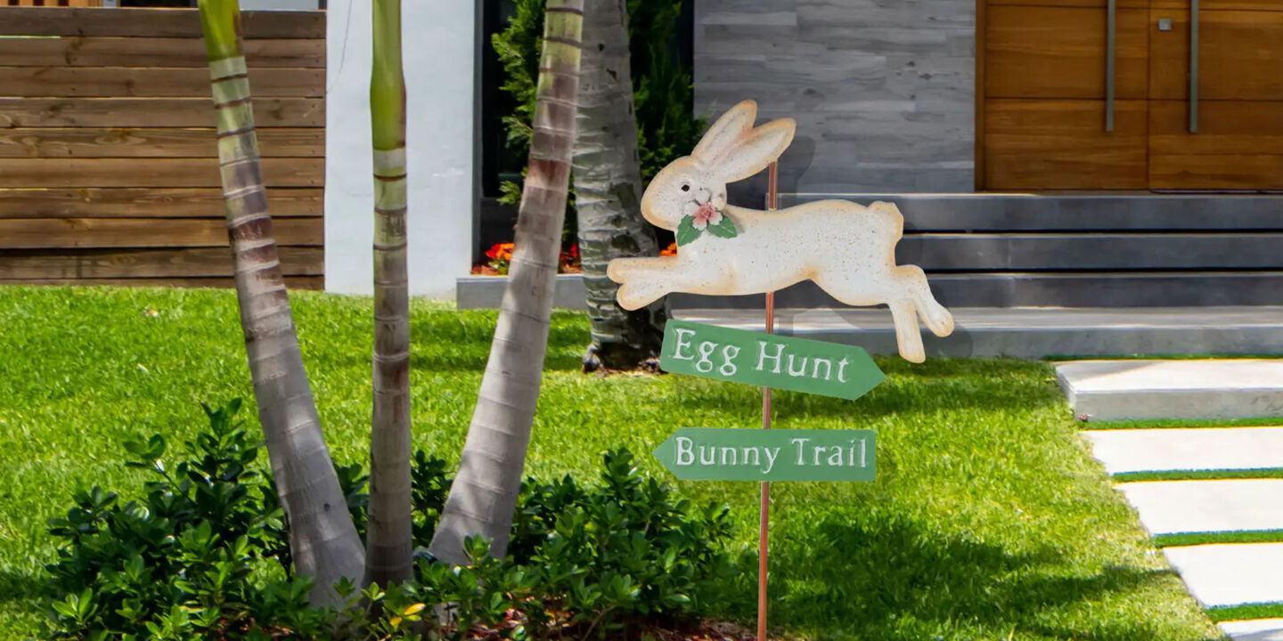 Yard with a green and white Easter bunny yard sign