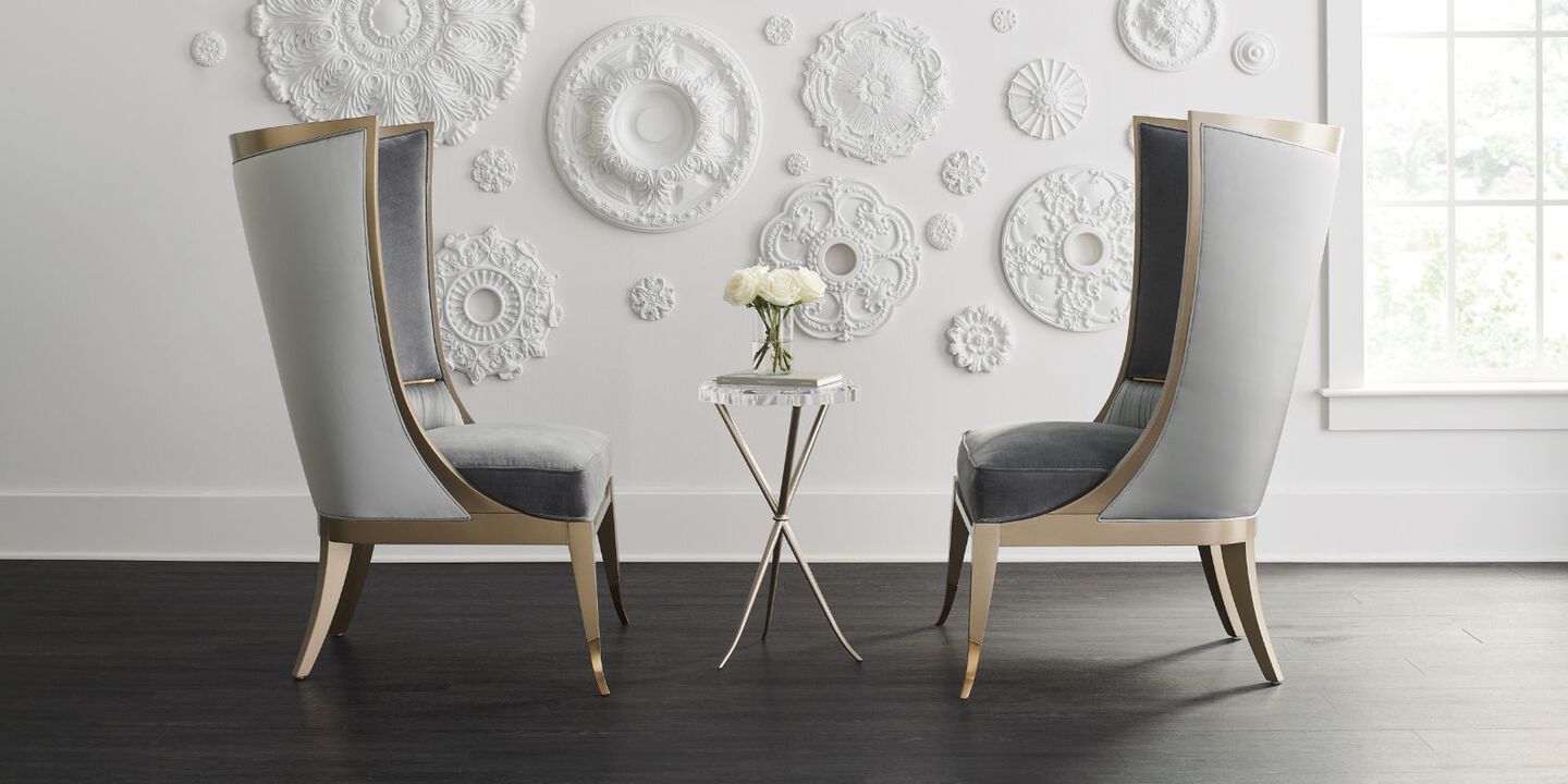 two grey statement chairs with light gold edges