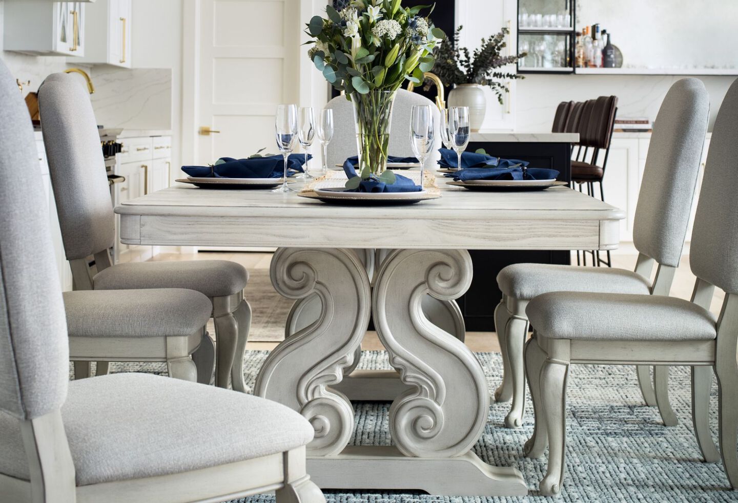 Dining room with white ornate dining table and matching white dining chairs