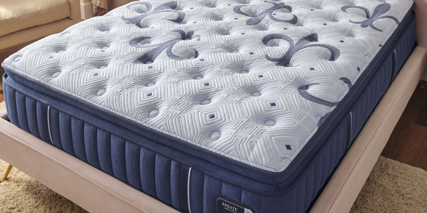 Light blue and navy mattress on a pink plush bedframe