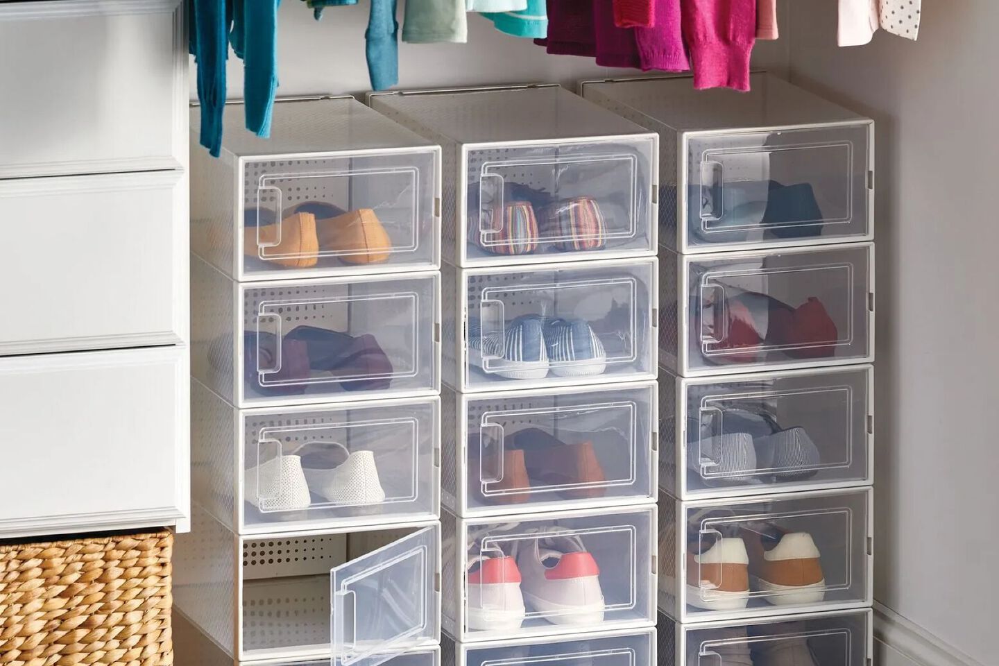 Closet with clear and white plastic shoe organizer filled with shoes