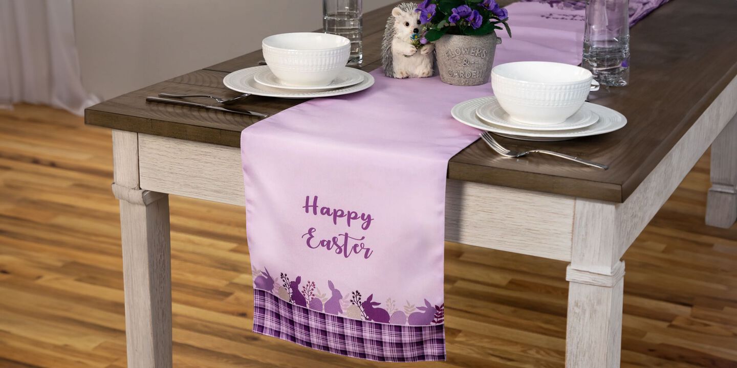 Table with a purple table runner with "Happy Easter" printed on it