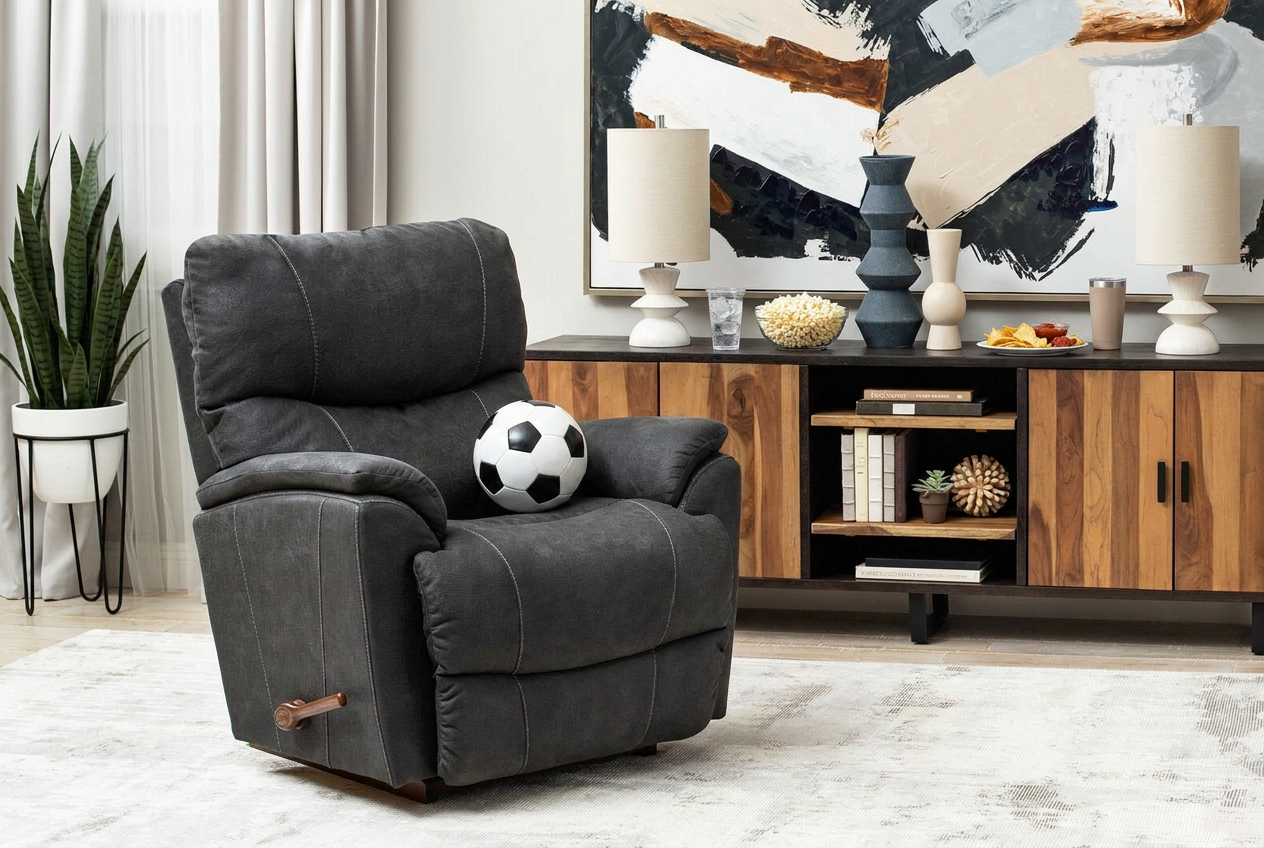 Charcoal manual recliner with a soccer ball in the seat and a credenza lined with snacks in the background.