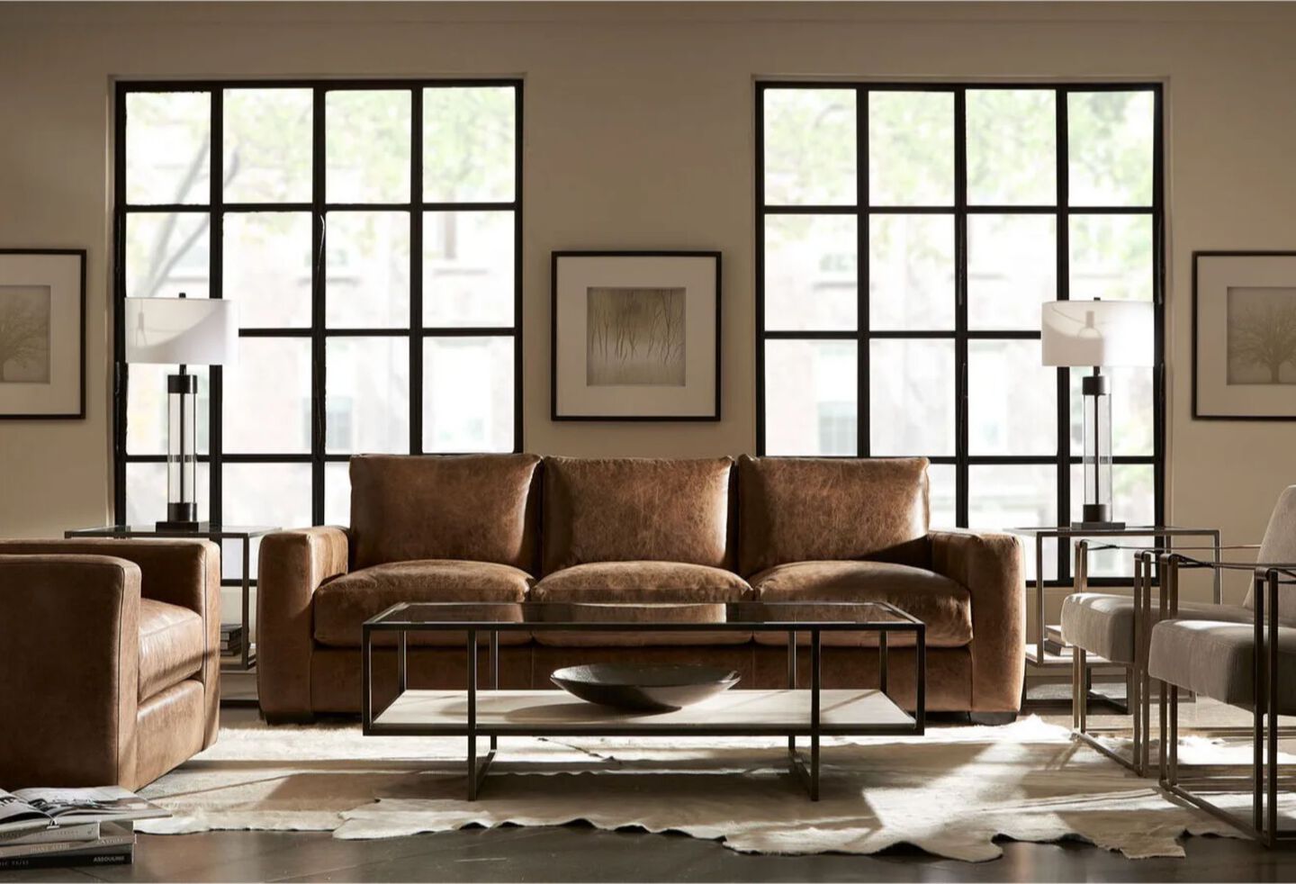 Living room with brown leather couch and recliner, two light grey chairs, and a black metal coffee table 