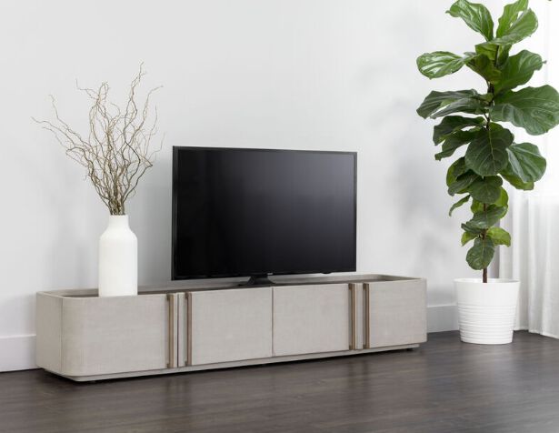A modern low-profile media console with a TV sitting on it along with minimal decor.