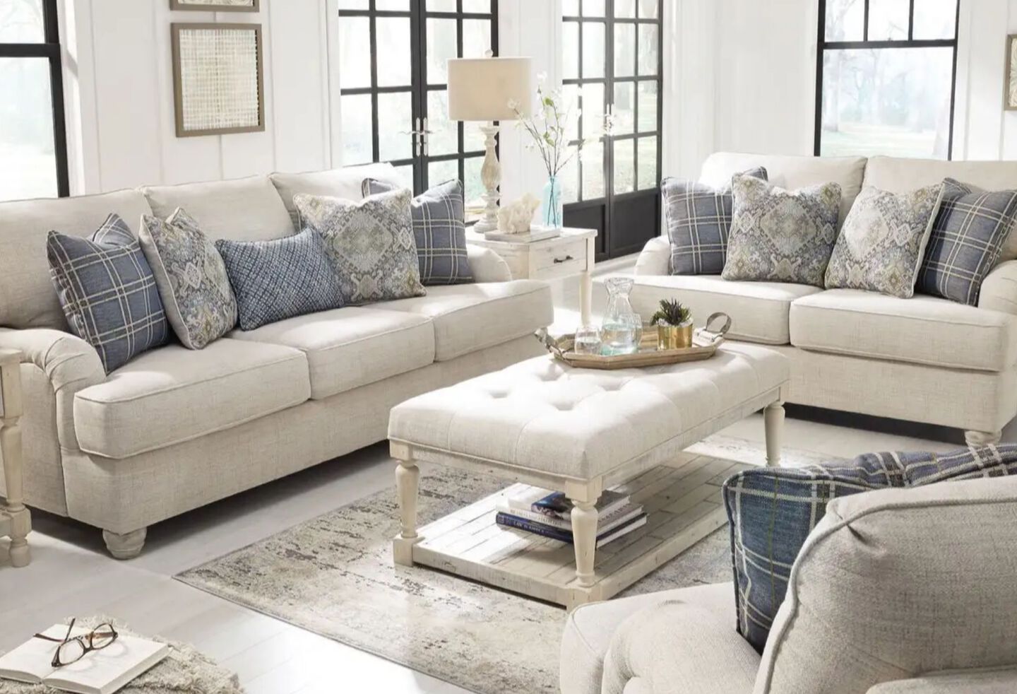 Living room with matching light grey couch, loveseat, and upholstered coffee table