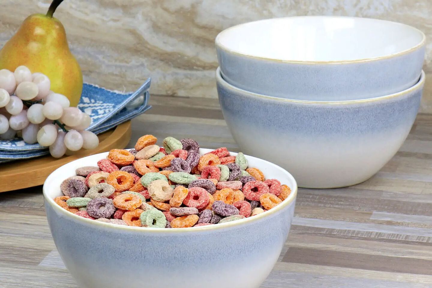 Countertop with three light blue and white ceramic bowls, one filled with cereal
