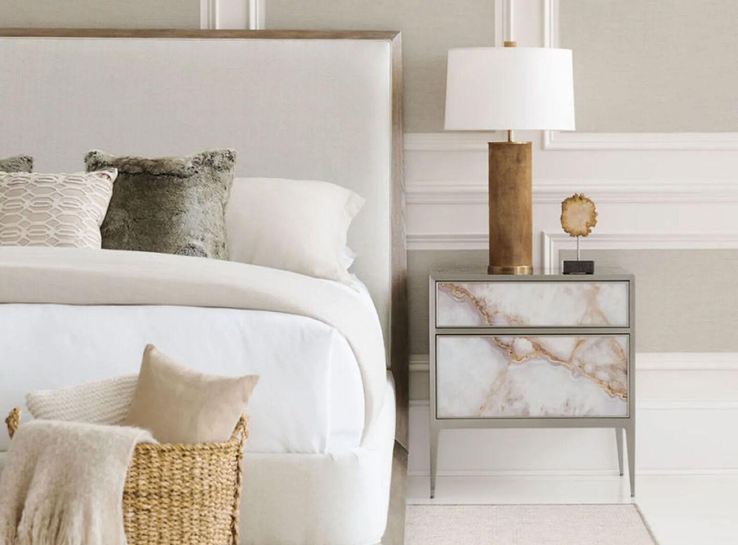 Bedroom with white bed and a white marble nightstand with silver hardware