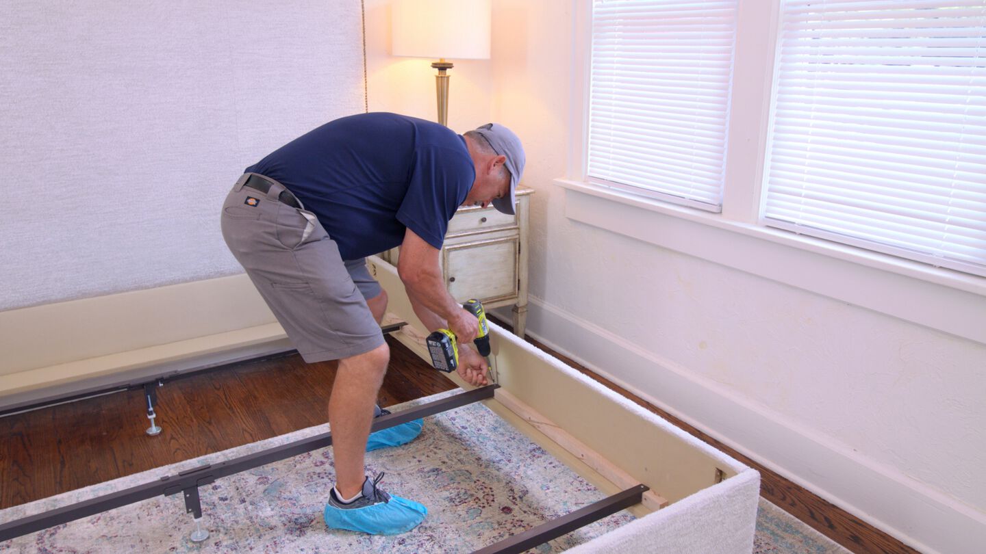 Mathis Home delivery associate assembling a bed in a customer's home during white glove delivery