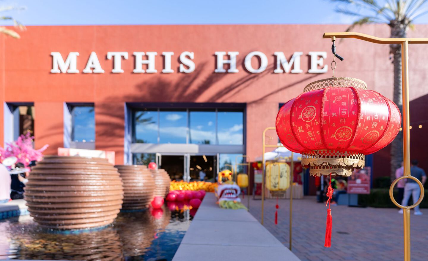 The Mathis Home storefront in Irvine with a red and gold lantern and decorations in front