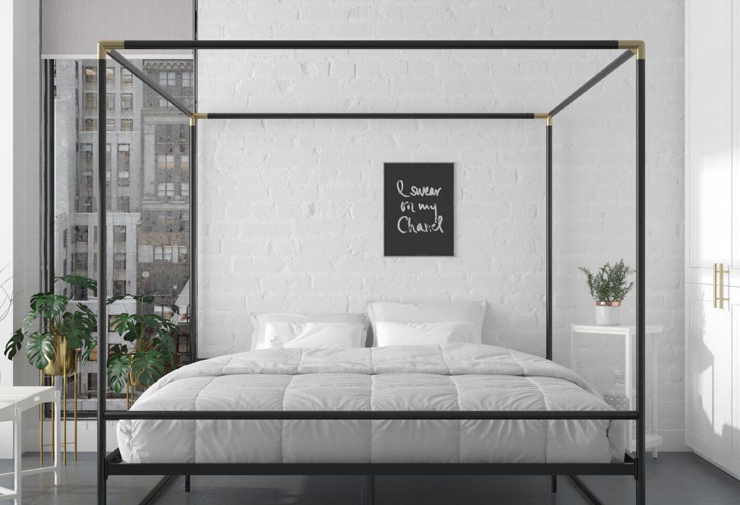 Black metal canopy bed frame with white bed below