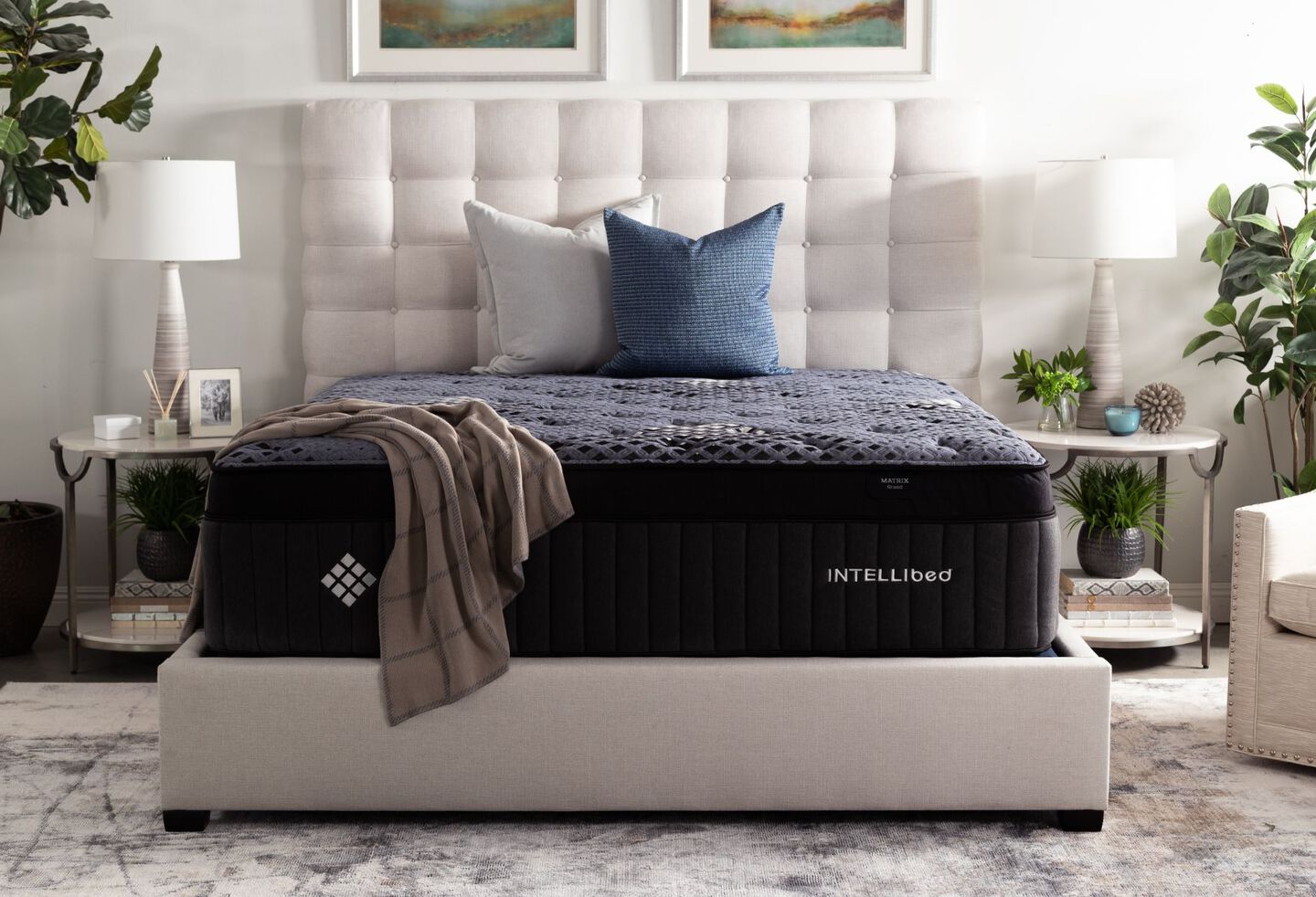 Navy blue mattress on top of a grey bedframe