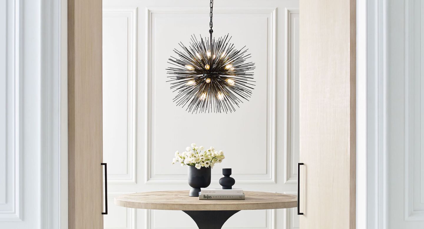Dining room with an abstract black light fixture hanging from the ceiling