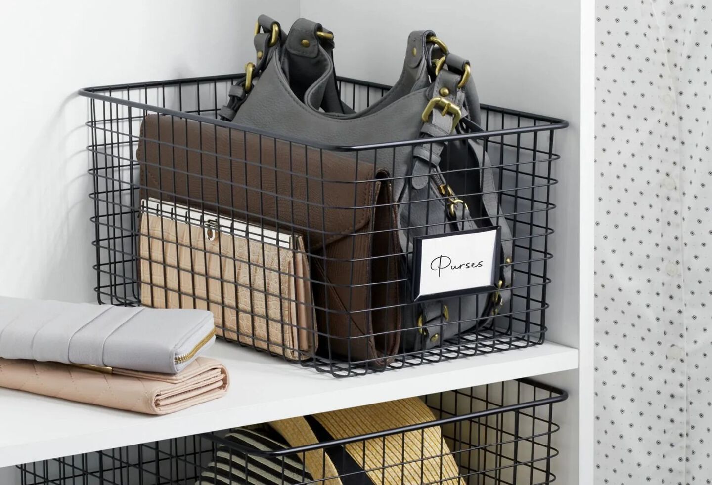 Closet shelf with black wire basket with purses and wallets inside