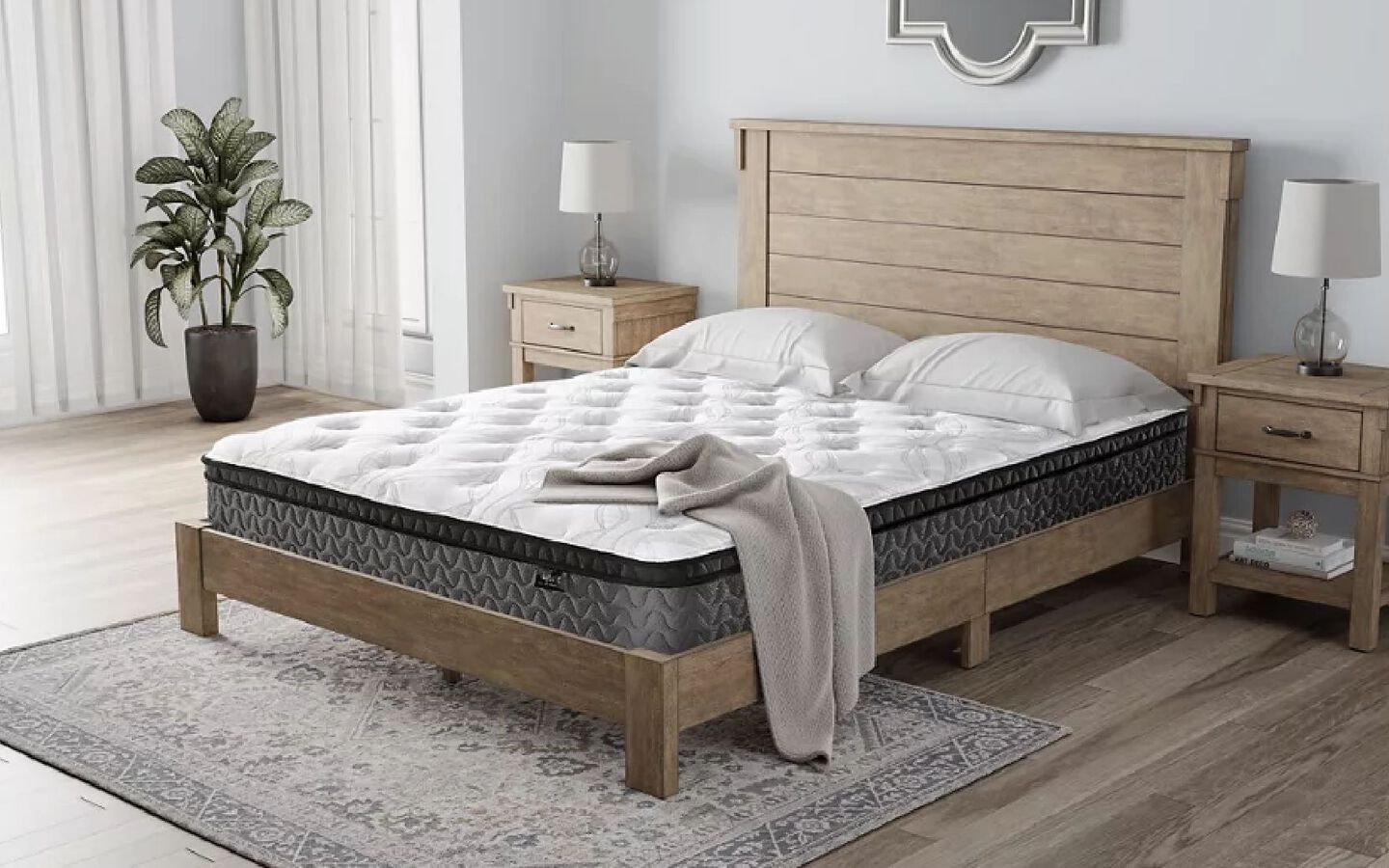 Grey and white mattress on a wooden panel bedframe in the middle of a bedroom setting