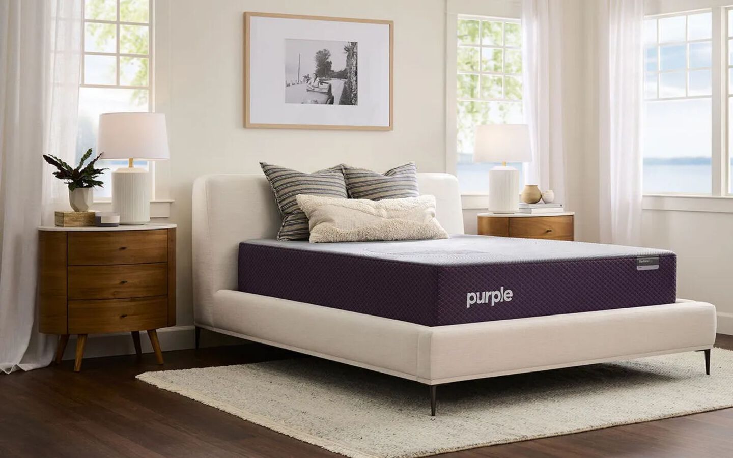 Purple mattress in a bedroom with two nightstands and open windows