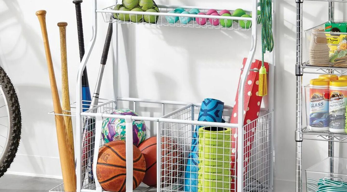 White wire storage rack with various sports supplies inside