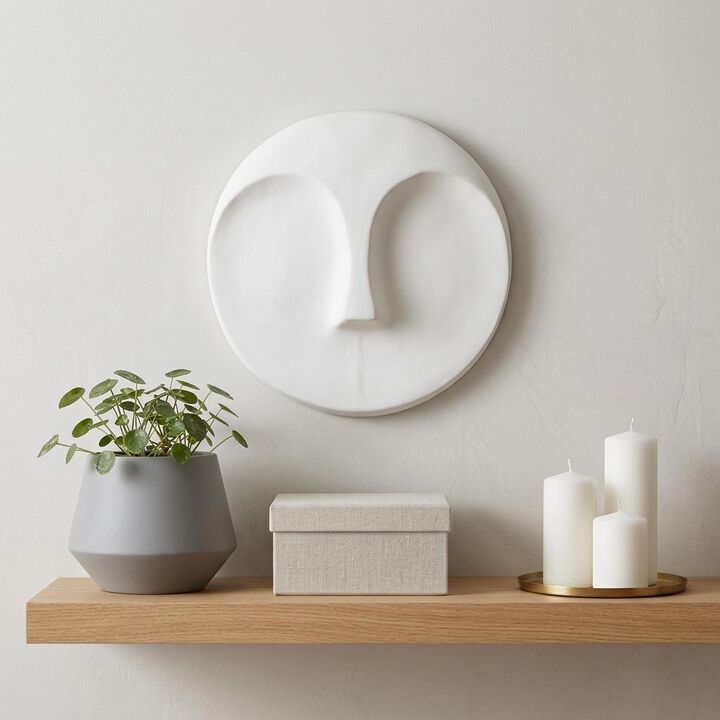HomeRoots 10" White Ceramic Face Round Wall Decor