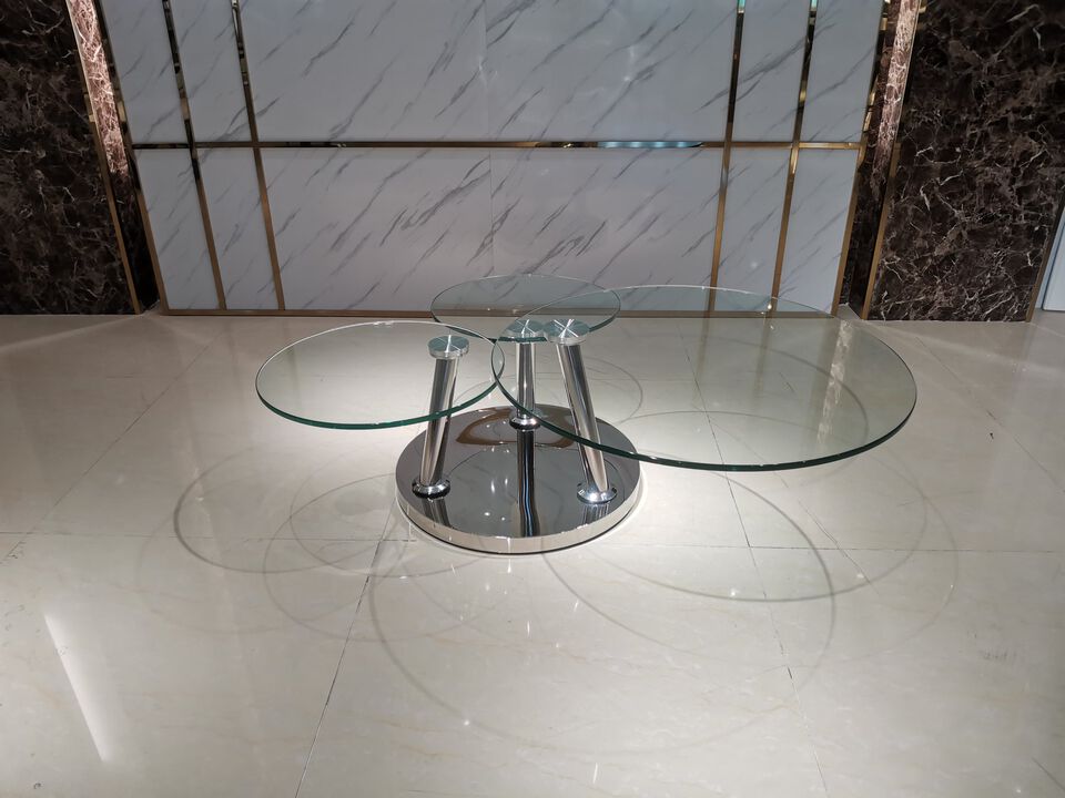 Motion coffee table with clear glass  top and chrome base