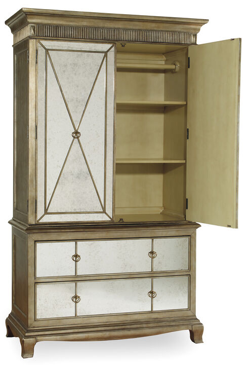 Sanctuary Armoire in Gold with one door open exposing the inside of the armoire with two shelves and a clothing rod.