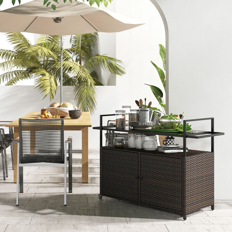 Outsunny PE Rattan Outdoor Bar Table, Outdoor Kitchen Island with 2-Tier Shelf & Cabinet, Patio Serving Cart with Glass Top, Handles, Towel Racks for Poolside, Garden, Mixed Brown