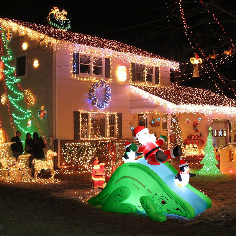 LuxenHome Santa and Penguins Trio Sliding on a Dinosaur Inflatable Holiday Decoration