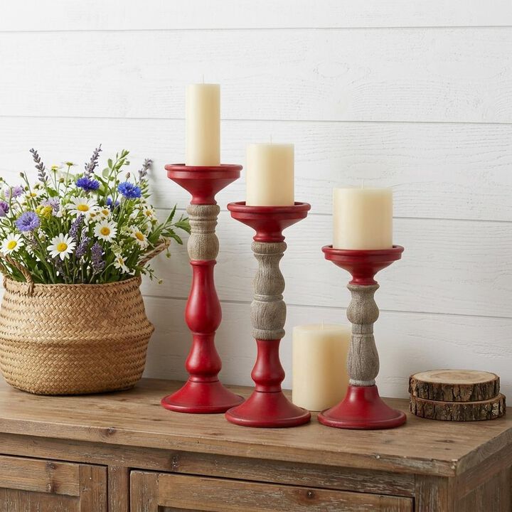 HomeRoots Set of Three Red And Natural Ornate Resin Tabletop Pillar Candle Holders