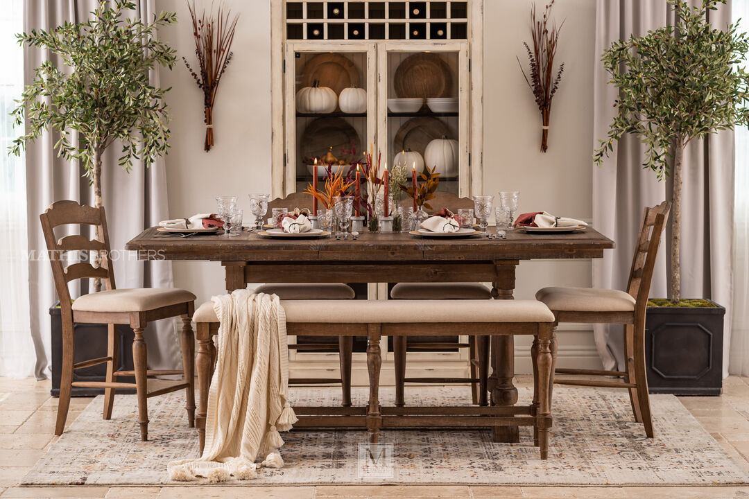 Augusta Tall Dining Table With Leaf with four chairs and one bench, in a dining room setting 