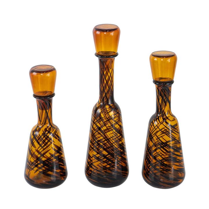 HomeRoots Set of Three Amber Abstract Swirl Glass Decorative Bottles With Stoppers