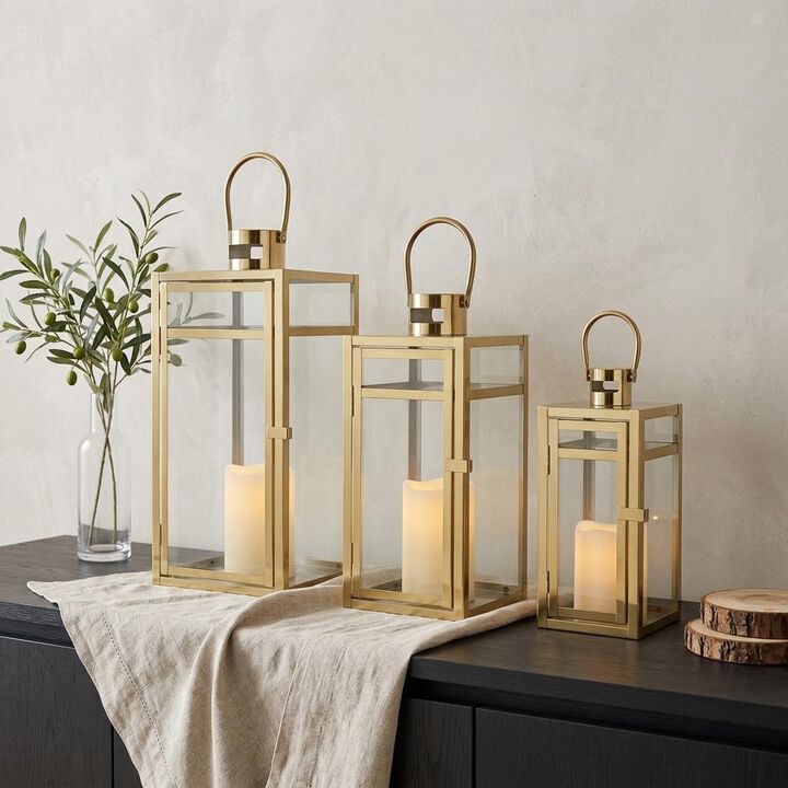 HomeRoots Set of Three Clear And Gold Glass And Stainless Steel Tabletop Lantern Candle Holders