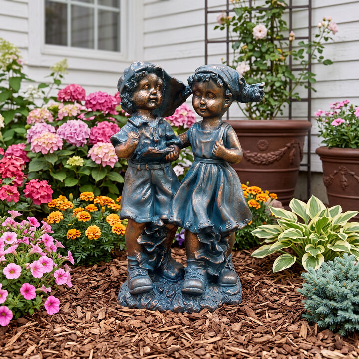 Joxti statues of a boy and a girl