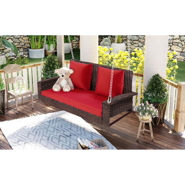 2-Person Wicker Hanging Porch Swing with Chains, Cushion, Pillow, Rattan Swing Bench for Garden, Backyard, Pond. (Brown Wicker, Red Cushion)