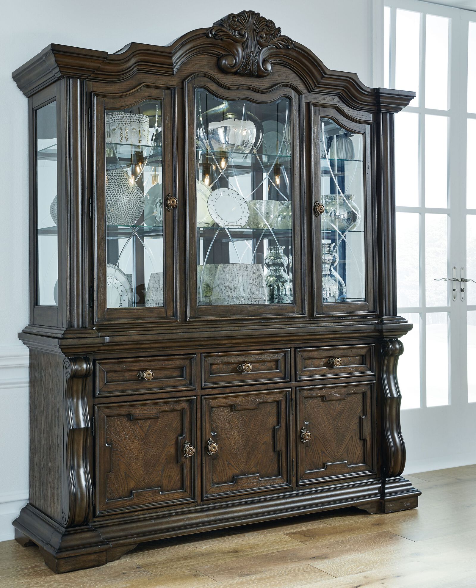 Traditional dark wood china hutch with glass-door upper display cabinet over a base cabinet